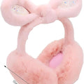Pink plush dumbbell-shaped toy with rhinestone accents on a white background