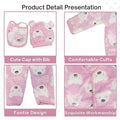 Baby clothing set with cap, bib, and footies featuring bear designs on a pink background.