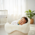 Baby sleeping in a white basket with a blurred background