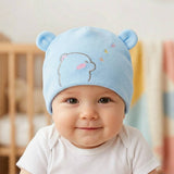 Baby wearing a blue bear hat in a nursery setting