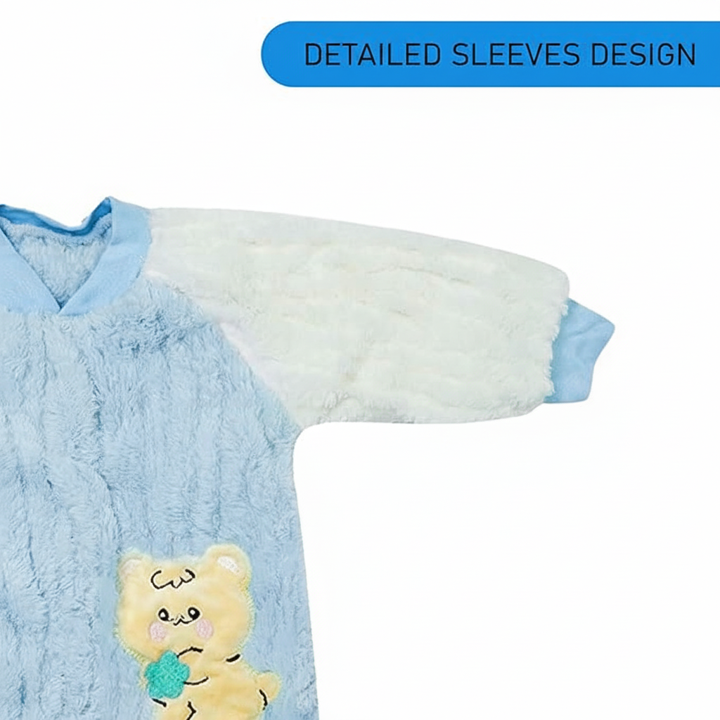 Blue baby outfit with white sleeves and a cartoon character patch on a white background
