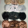 Collection of dog toys with fluffy ends on a light background