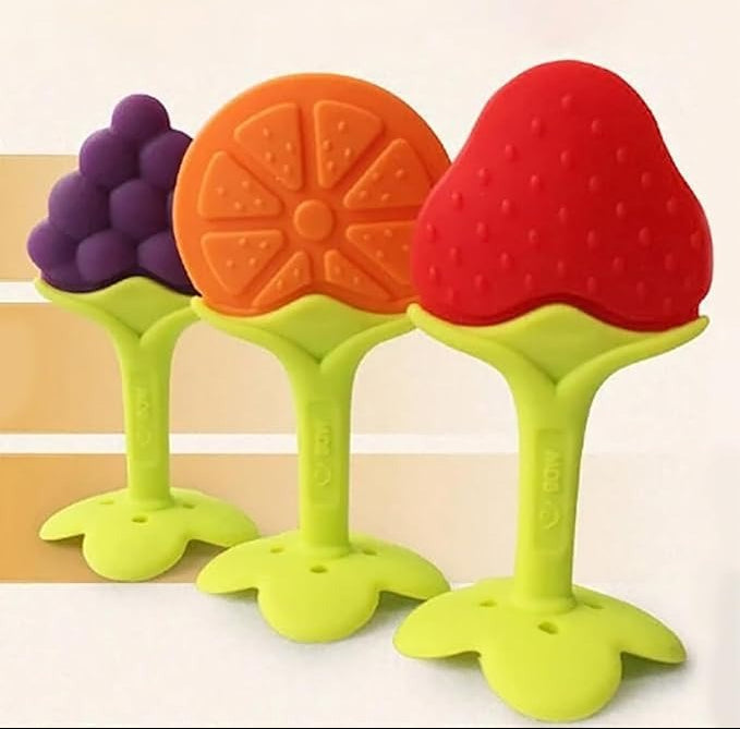 Colorful baby teether toys shaped like fruits on a white background