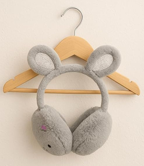 Gray bunny-shaped earmuffs on a wooden hanger against a beige background