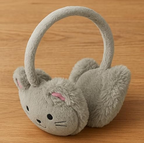 Gray plush cat-shaped ear muffs on a wooden surface