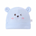 Light blue baby hat with bear ears and face on a white background