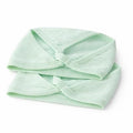 Light green headband with a twisted design on a white background