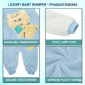 Luxury baby romper with embroidered bear, cozy cuffs, secure foot design, and supreme plush fabric on a blue background.