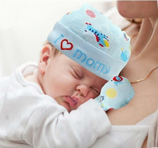Newborn baby wearing a colorful 'I love mommy' hat and matching blanket.