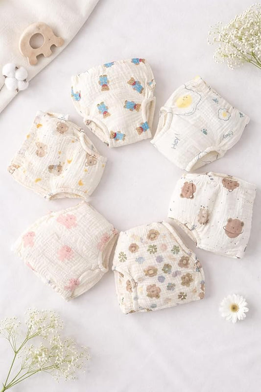 Set of baby bloomers with floral and animal prints on a light background