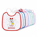 Set of colorful baby bibs with cartoon dog design and 'MONDAY' text on a white background