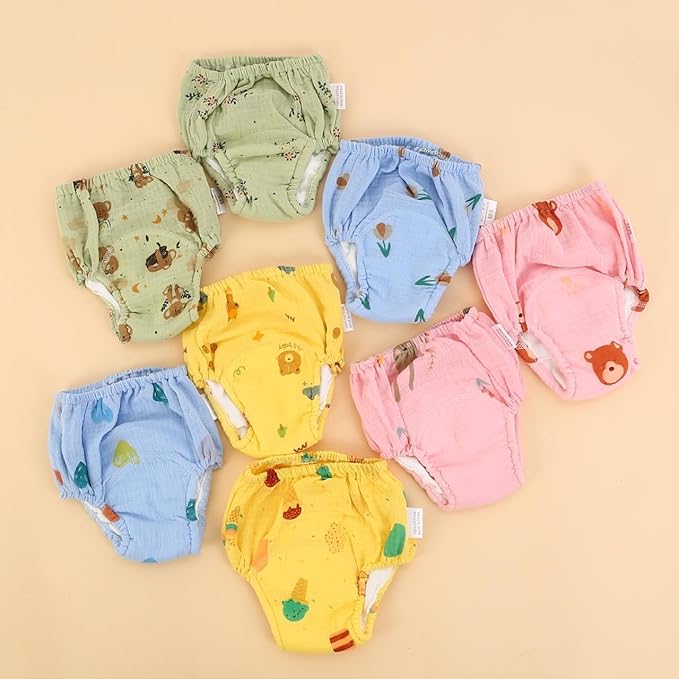 Set of colorful baby bloomers with animal prints on a beige background