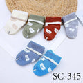 Set of colorful baby socks with animal prints on a white background
