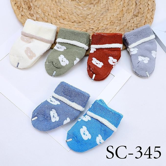 Set of colorful baby socks with animal prints on a white background