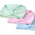 Three pastel-colored headbands (green, pink, and blue) on a white background