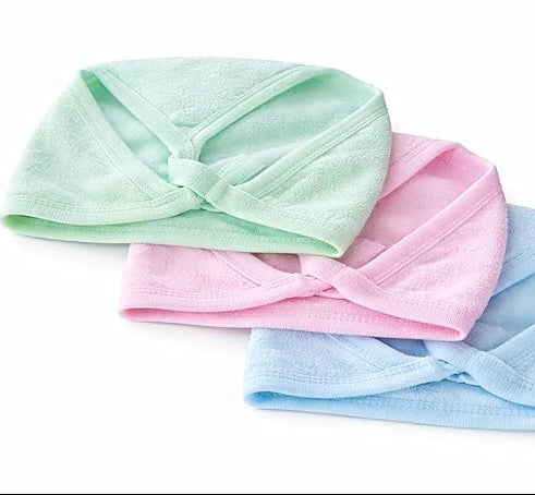 Three pastel-colored headbands (green, pink, and blue) on a white background