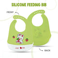 Green silicone feeding bib with cartoon design on front and back, featuring the brand 'Just Smile'.