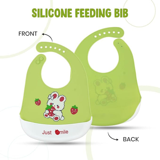 Green silicone feeding bib with cartoon design on front and back, featuring the brand 'Just Smile'.