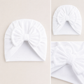 White baby turban on a beige background