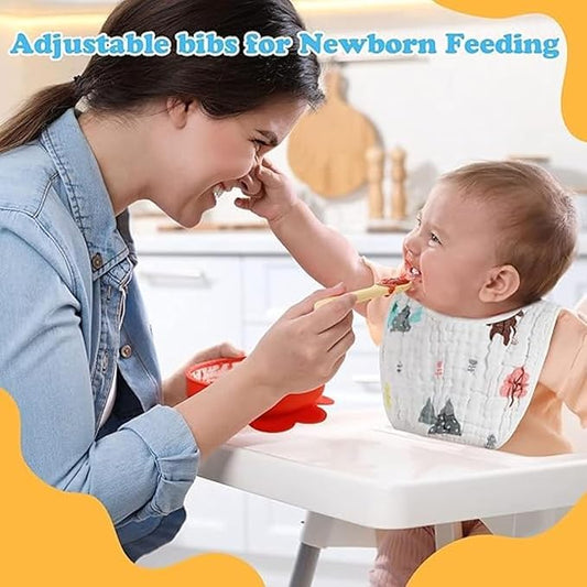 Woman feeding a baby in a high chair with an adjustable bib, set against a blurred kitchen background.
