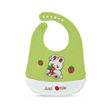 Green baby bib with cartoon design and 'Just Smile' text on a white background
