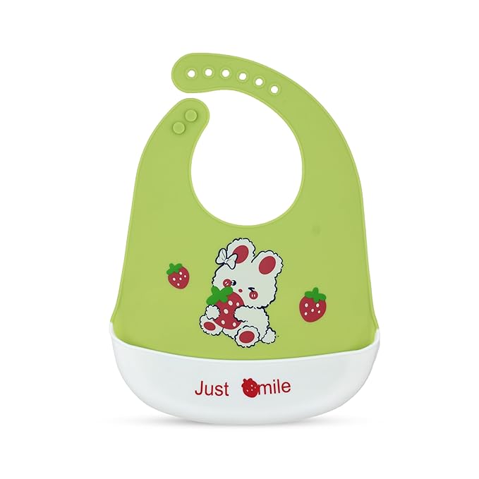 Green baby bib with cartoon design and 'Just Smile' text on a white background