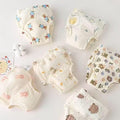 Set of baby diapers with cartoon designs on a light background