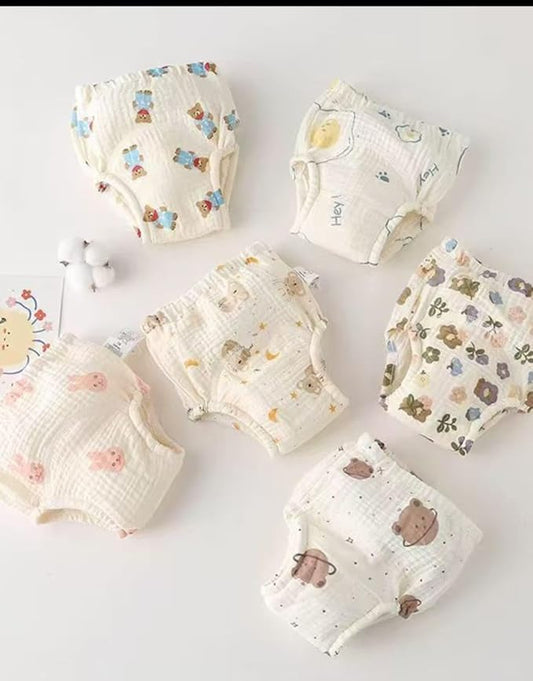 Set of baby diapers with cartoon designs on a light background