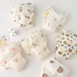Set of baby diapers with cartoon designs on a light background