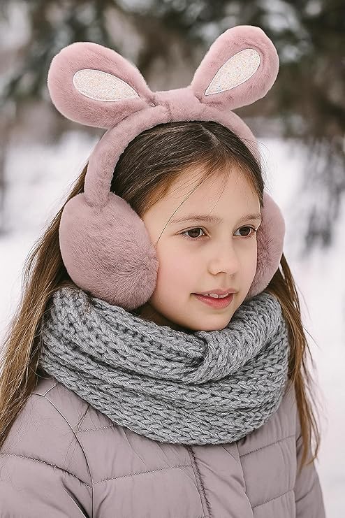 Child wearing pink bunny ear headband and gray scarf in snowy setting